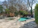 Large freeform pool and spa with ample patio space at 1408 Edgewater Dr, Charlotte, NC 28210