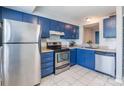 Blue cabinets, stainless steel appliances, and white tile backsplash at 182 Water Oak Dr, Pineville, NC 28134