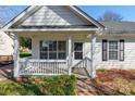 Quaint front porch with white railings and access to the front door at 210 Lauren Dr, Indian Trail, NC 28079