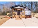 Modern farmhouse exterior, featuring a covered front porch and freshly landscaped yard at 277 Melrose Sw Dr, Concord, NC 28025