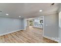 Open concept living room with hardwood floors and an adjacent kitchen at 277 Melrose Sw Dr, Concord, NC 28025