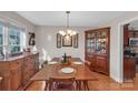 Formal dining room featuring hardwood floors, a wooden table, and a china cabinet at 305 Goldfinch Ct, Shelby, NC 28150