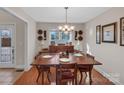 Bright dining area with hardwood floors and a view into the kitchen at 305 Goldfinch Ct, Shelby, NC 28150