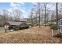 View of the brick home from the backyard with mature trees providing plenty of privacy at 330 Regency Rd, Salisbury, NC 28147