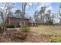 Landscaped yard with mature trees and a swing set at 330 Regency Rd, Salisbury, NC 28147