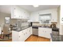 Well-lit kitchen featuring white cabinets and stainless steel appliances at 330 Regency Rd, Salisbury, NC 28147