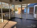 Covered screened porch with wooden floor and ceiling fan overlooking backyard and brick home at 330 Regency Rd, Salisbury, NC 28147