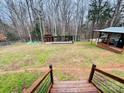 Spacious backyard with shed, chicken coop and stairs leading up to the house at 334 Stanley Spencer Mtn Rd, Gastonia, NC 28056