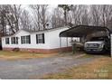 Manufactured home with carport, truck, and boat at 334 Stanley Spencer Mtn Rd, Gastonia, NC 28056