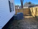 AC unit in the backyard with a wooden fence at 518 W White St, Chester, SC 29706