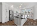 Modern kitchen with white shaker cabinets, stainless steel appliances, and an island at 5605 Miami Ln, Concord, NC 28025