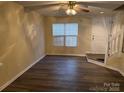 Bright and spacious living room with laminate flooring and ceiling fan at 5732 Prescott Ct, Charlotte, NC 28269