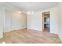 Dining room with light walls and wood flooring, open to the kitchen at 5763 Crown Ter, Hickory, NC 28601