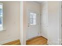 Bright entryway with wood-look flooring, white door, and access to other rooms at 5763 Crown Ter, Hickory, NC 28601