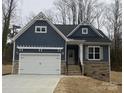 Dark blue and light brown two-story house with a two-car garage at 5775 Crown Ter, Hickory, NC 28601