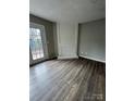 Living room featuring a fireplace and dark laminate flooring at 6126 Bent Tree Ct, Charlotte, NC 28212