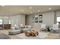 Open living space featuring a neutral color scheme and stylish furnishings at 718 Falling Oak Aly, Huntersville, NC 28078