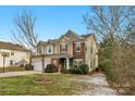 Two-story house with stone accents and a landscaped yard at 7845 Kuck Rd, Mint Hill, NC 28227