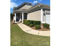 Charming home exterior with manicured landscaping, a covered porch, and attached garage at 8024 Carolina Lakes Way, Fort Mill, SC 29707