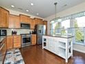 Bright kitchen features a butcher block island, stainless steel appliances and natural light at 8024 Carolina Lakes Way, Fort Mill, SC 29707