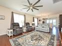 Cozy living room with ample seating, a ceiling fan, and natural light from the windows at 8024 Carolina Lakes Way, Fort Mill, SC 29707