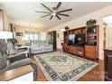 Spacious living room features a ceiling fan, beautiful rug, and comfortable seating at 8024 Carolina Lakes Way, Fort Mill, SC 29707