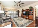 Living room showcasing hardwood floors, a ceiling fan, and comfortable seating at 8024 Carolina Lakes Way, Fort Mill, SC 29707