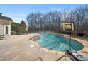 Relaxing pool area with basketball hoop nearby at 8440 Mossy Cup Trl, Harrisburg, NC 28075