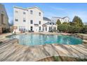 Inviting kidney-shaped pool with stone coping at 8440 Mossy Cup Trl, Harrisburg, NC 28075