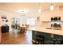 Modern kitchen featuring white cabinets, an island, and stainless steel appliances at 9009 Powder Works Dr, Huntersville, NC 28078