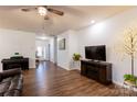 Spacious living room features a fireplace, ceiling fan, and hardwood-style flooring at 9009 Powder Works Dr, Huntersville, NC 28078