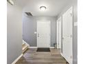 Bright entryway with gray walls, wood-look floors, and staircase at 9022 Belle Bragg Way, Charlotte, NC 28214