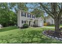 Two-story house with gray siding, a white door, and a two-car garage at 9022 Belle Bragg Way, Charlotte, NC 28214