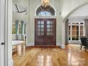 Grand entryway with hardwood floors and elegant double doors at 9117 Monarchos Ct, Waxhaw, NC 28173