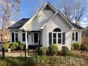 Charming home featuring black window shutters and a well-manicured lawn at 926 Lone Oak Ln, Mooresville, NC 28115