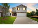 Two-story house with gray siding, stone accents, and a two-car garage at dusk at 1020 20Th Avenue Se Way, Hickory, NC 28602