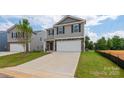 Two-story house with gray siding, stone accents, and a two-car garage at 1020 20Th Avenue Se Way, Hickory, NC 28602