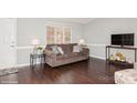 Living room with brown sofa and dark hardwood floors at 10414 Club Car Ct, Mint Hill, NC 28227