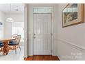 Bright entryway with hardwood floors and dining room view at 11104 Fox Cove Dr, Charlotte, NC 28273