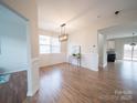 Bright dining room with hardwood floors, wainscoting, and modern light fixture at 1120 Spicewood Pines Rd, Fort Mill, SC 29708