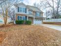 Two-story house with stone and siding accents, a two-car garage, and a landscaped yard at 1120 Spicewood Pines Rd, Fort Mill, SC 29708