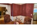 Formal dining room with wood floors and burgundy walls at 113 Rocky Trail Ct, Fort Mill, SC 29715