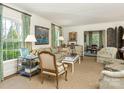 Bright living room with large windows, stylish furnishings, and decorative accents at 1136 Bolling Rd, Charlotte, NC 28207