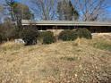 Brick ranch house with overgrown landscaping at 1191 Carolyn Dr, Albemarle, NC 28001