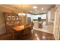 Kitchen and dining room with hardwood floors and an island at 12111 Frogs Leap Ct, Charlotte, NC 28277