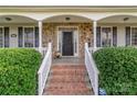 Brick steps leading to a front porch with stone accents and white railings at 1265 Maddy Ln, Rock Hill, SC 29732