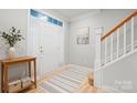 Inviting entryway with hardwood floors, staircase, and a decorative table at 135 Singleton Rd, Mooresville, NC 28117
