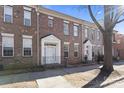 Attractive brick townhome featuring white trim, a front door, and a small wrought iron fenced in patio at 135 Singleton Rd, Mooresville, NC 28117