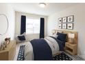 Bright bedroom with a full bed, dresser and stylish decor at 14123 Penbury Ln # 360, Charlotte, NC 28278