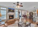 Inviting living room featuring a stone fireplace, wood floors, and ample natural light at 153 Snead Rd # 72, Fort Mill, SC 29715